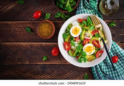 Fresh avocado salad with tomato, avocado, boiled eggs and fresh lettuce. Ketogenic diet breakfast.  Keto, paleo salad. Top view, overhead, above - Powered by Shutterstock