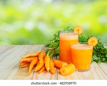 Fresh baby carrot vegetable and glass of carrot juice  on wooden table of natural background
