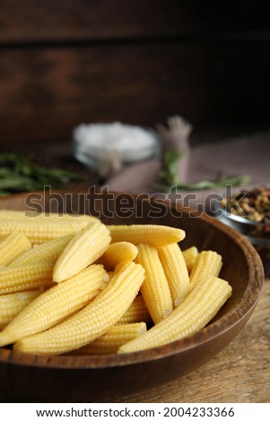 Fresh baby corn cobs on wooden table