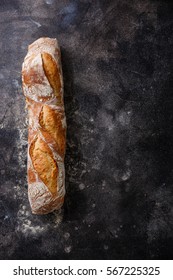 Fresh Baguette bread on dark background copy space - Shutterstock ID 567225325