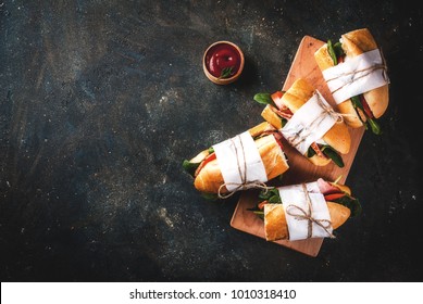 Fresh Baguette Sandwich With Bacon, Cheese, Tomatoes And Spinach, Dark Blue Background Copy Space Top View