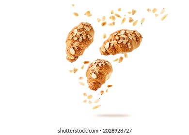 Fresh Baked Almond  Breakfast Croissants  With Nuts Flakes And Crumbs Flying Isolated On White Background. Three Croissants Falling. Pastry Shop Card.