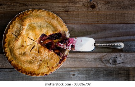 Fresh baked blueberry and peach pie sitting on a wooden surface, overhead shot. - Powered by Shutterstock