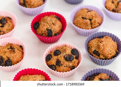 Fresh Baked Bran Muffins With Dry Cranberries In Muffin Cups On White Background, Top View. Healthy Food, Good Source Of Dietary Fiber