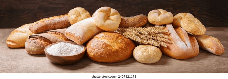 Fresh baked bread, flour and wheat ears on wooden background - Powered by Shutterstock