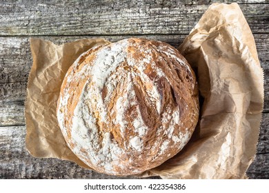 Fresh baked bread loaf on rustic wooden table - Shutterstock ID 422354386