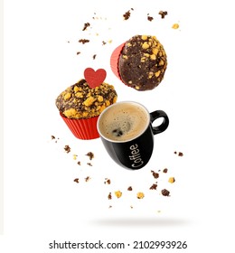 Fresh Baked Chocolate Lemon Muffin With Heart Crumbs And Black Cup Hot Espresso Coffee Flying Isolated On White Background. Two Muffins In Red Form And Cup Falling. Pastry Shop Or Cafe Card.