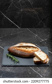 Fresh baked crunchy durum rosemary bread with a decorative score. - Shutterstock ID 2209277775