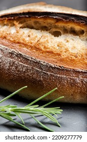 Fresh baked crunchy durum rosemary bread with a decorative score. - Shutterstock ID 2209277779