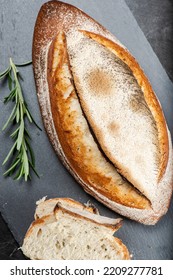 Fresh baked crunchy durum rosemary bread with a decorative score. - Shutterstock ID 2209277781