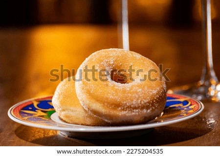 Fresh baked doughnuts or donuts sweet dessert americal style glazed with sugar close up