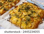 Fresh baked focaccia, pala romana pizza with potato vegetables and rosemary in bakery in Parma, Emilia Romania, Italy