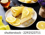 Fresh baked homemade lemon cheesecake with lemon curd and lemon slices.