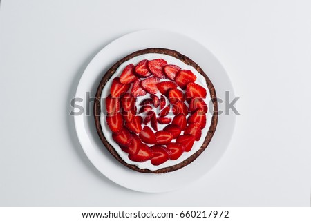 Fresh baked homemade pie with strawberries and whipped cream and cinnamon on rustic background. close-up. top or overhead view. Thanksgiving Desserts or cake sweet pastry. copy space. 