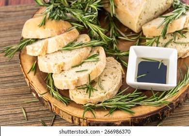 a fresh baked loaf of rosemary bread and olive oil and balsamic vinegar