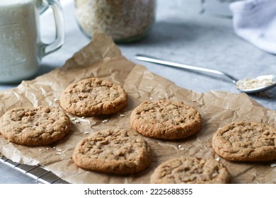 Fresh Baked Oatmeal Cookies On Baking Rack, Milk And Oats In Background. High Quality Photo