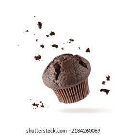 Fresh baked single chocolate muffin with crumbs flying on white background. Sweet dark cupcake falling. Pastry card with copy space - Shutterstock ID 2184260069