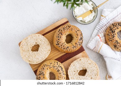 Fresh baked sourdough New York style bagels with philadelphia cheese on light table, top view - Powered by Shutterstock