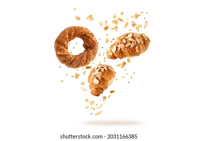 Fresh Baked Turkish Simit Sesame Bagel, French Butter Almond Nut Croissants Flying With Seeds, Flakes And Crumbs Isolated On White Background. Pastry Shop Card