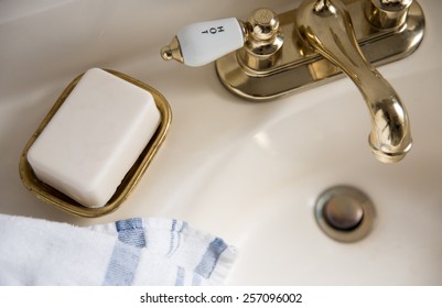 Fresh Bar Of Artisan Soap Next To Brass Vintage Sink