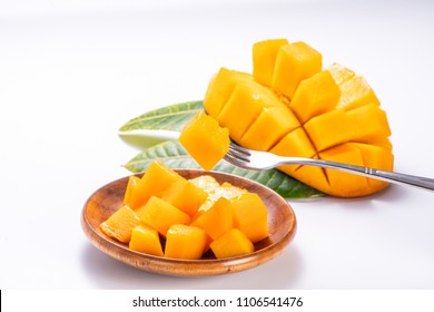 Fresh and beautiful mango in a wooden plate with sliced diced mango chunks isolated with 

white background, copy space(text space), blank for text
