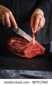 Fresh Beef Butcher Meat. Farmer Hand Holding Eco Meat Of Muscle Meat Beef Ready To Cook Over Black Marble Table. 