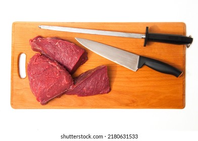Fresh Beef Meet On Wooden Board With Knife And Musat Shop Sign
