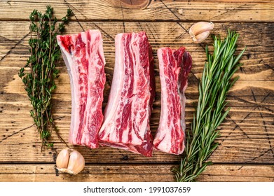 Fresh Beef short ribs on butcher wooden table. Wooden background. Top view