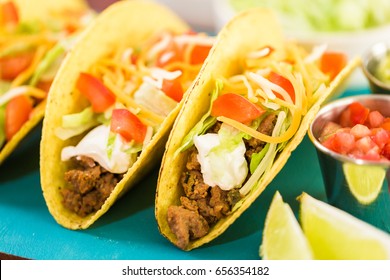 Fresh Beef Tacos In Hard Yellow Corn Taco Shell With Sour Cream And Shredded Cheese.