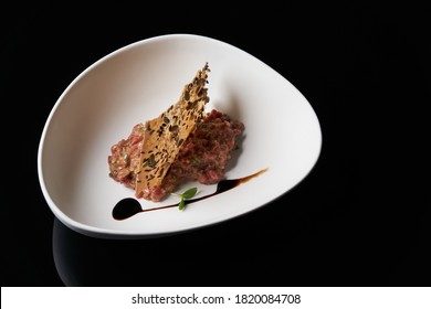 Fresh Beef Tartar With Whole Grain Chips. Raw Tartar Meat In White Plate On Table