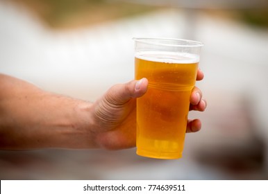 Fresh Beer In A Plastic Cup In The Hand