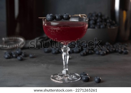 Fresh berries cocktail with bluenerries. Summer cold drink and cocktail on dark background.
