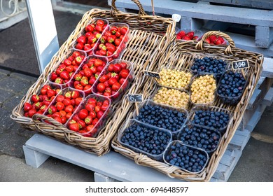 Fresh berries of strawberries and blueberries on the market