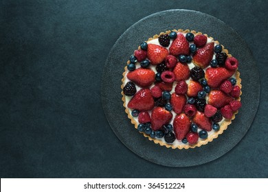 Fresh Berry Fruit Tart, Overhead View On Border Background