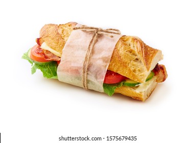 Fresh big baguette sandwich with bacon, chedder cheese, mustard, lettuce and vegetables isolated on white background