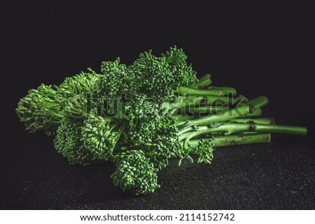 Fresh bimi vegetable on a dark table. Raw baby broccoli