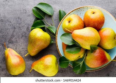 Fresh bio pear with leaves on the plate. Gray stone table. - Shutterstock ID 1469014424