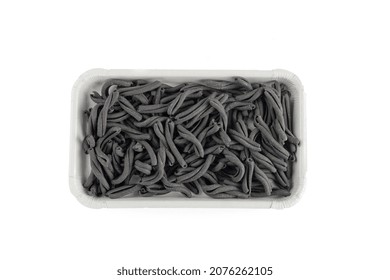 Fresh Black Casarecce Paste In A Delivery Box, Isolated On A White Background. Dry Pasta Texture