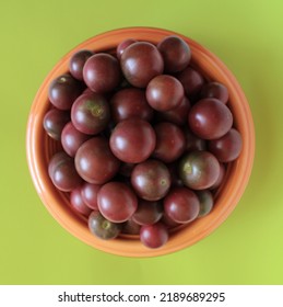 Fresh Black Cherry Tomatoes In An Orange Bowl