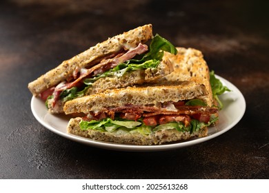 Fresh BLT Sandwiches With Bacon Lettuce And Tomato On White Plate