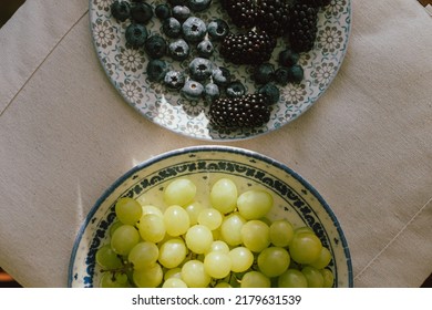 Fresh Blueberries, Blackberries And Grapes In Sunlight On Ceramic Plate Flat Lay. Healthy Food Aesthetics. Summer Berries In Light On Soft Linen Background. Moody Banner