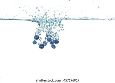 Fresh Blueberries Falling In Water On White Background