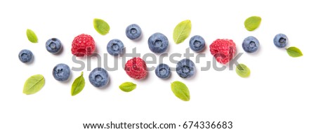 Fresh blueberries with leaves and raspberries, berry ornament isolated on white background, top view