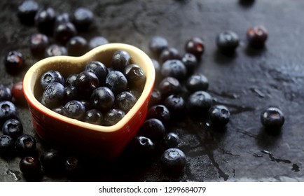 Fresh Blueberries On Slate Background In Heart Shape Dish