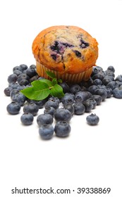 Fresh Blueberries Surround A Single Blueberry Muffin On A Light Background