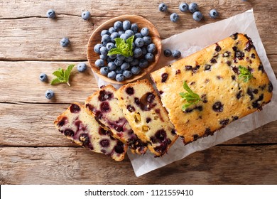 Fresh Blueberry Loaf Of Bread Muffin Cake With Mint Closeup On A Table. Horizontal Top View From Above
