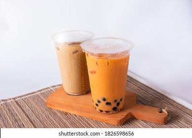 Fresh Boba Thai Tea And Palm Sugar Coffee Served On Wooden Plate With White Isolated Background