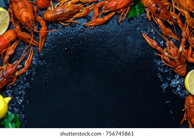 Fresh Boiled Crawfish With Lemons And Greens On A Dark Table With Ice. Copyspace For Text. Top View.