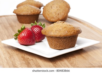 A Fresh Bran Muffin Against A White Background