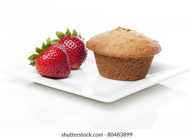 A Fresh Bran Muffin Against A White Background